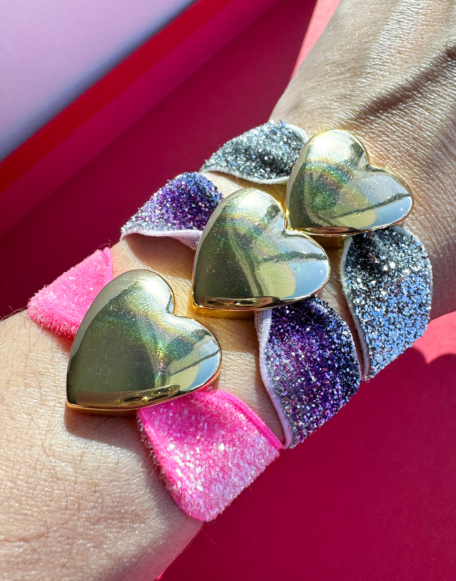Brazaletes Elásticos Rosa, Morado y Gris + Corazones Gold