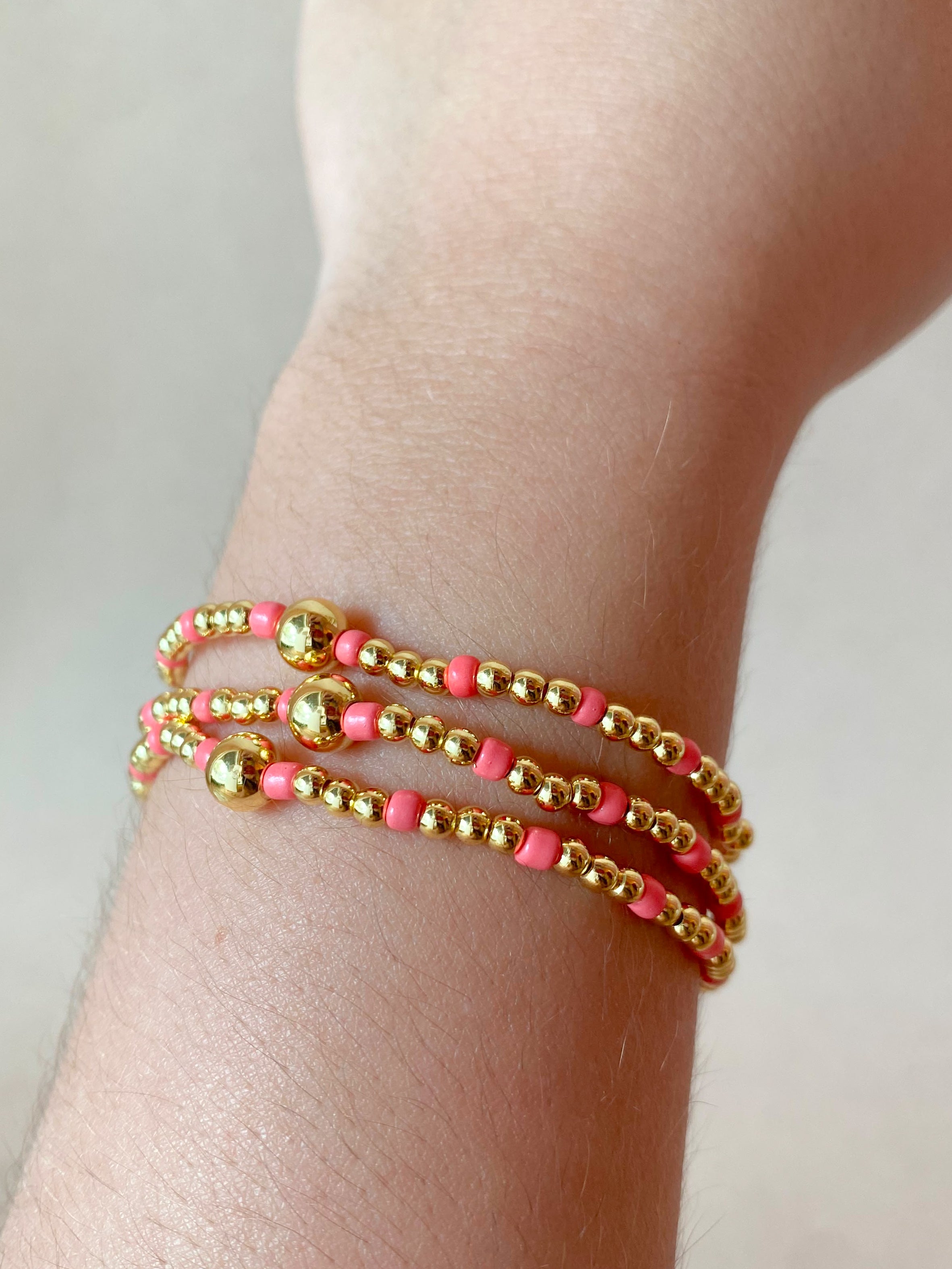 Set of 3 Elastic Golden and Pink Beads Bracelets